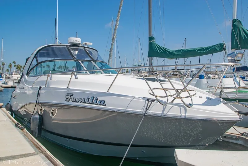 Slide: The Image of 2012 Rinker 310 Express Cruiser docked at marina under clear blue sky. - 5
