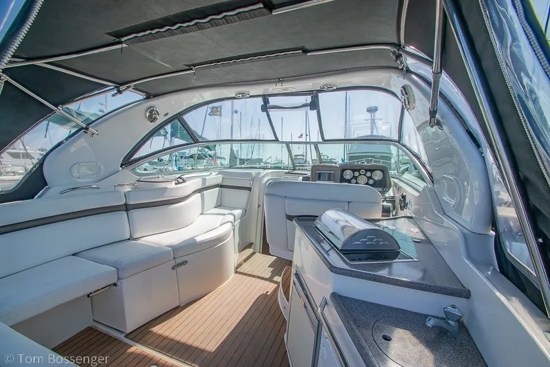 Slide: The Image of Interior of 2012 Rinker 310 Express Cruiser with seating and helm, showcasing luxury design. - 28