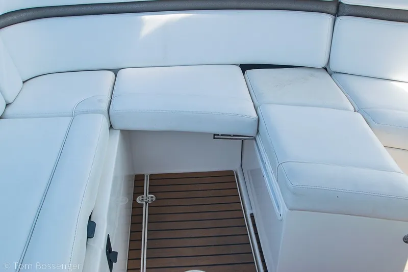 Slide: The Image of White seating area on 2012 Rinker 310 Express Cruiser with teak flooring. - 13