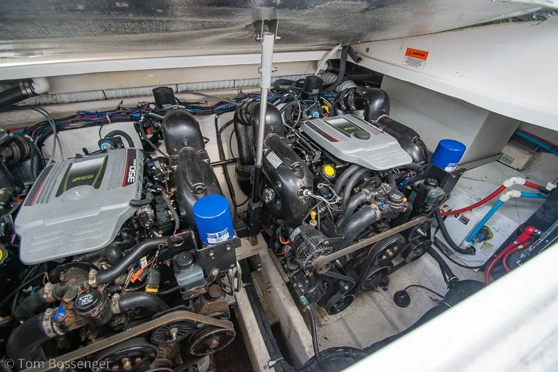 Slide: The Image of Engine compartment of a 2012 Rinker 310 Express Cruiser, showcasing dual engines and components. - 10