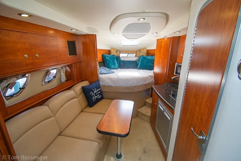 Slide: The Image of Interior of 2012 Rinker 310 Express Cruiser with cozy seating and modern amenities. - 14