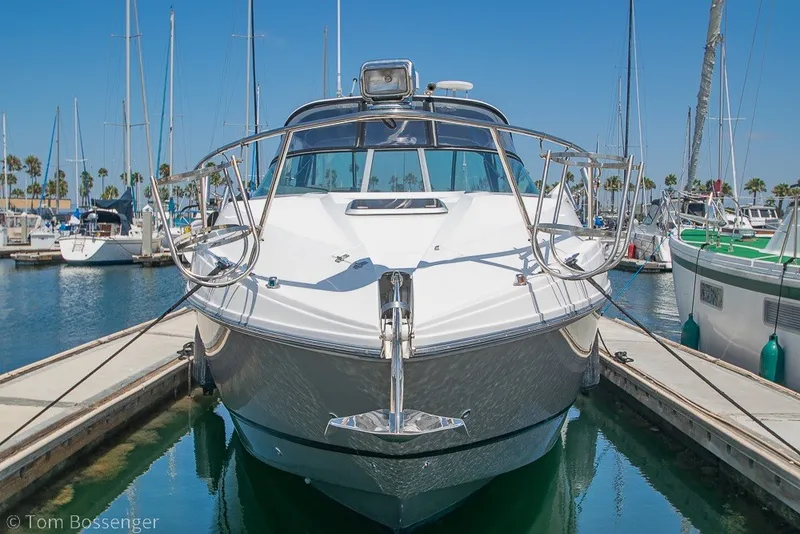 Slide: The Image of 2012 Rinker 310 Express Cruiser docked in a sunny marina. - 3