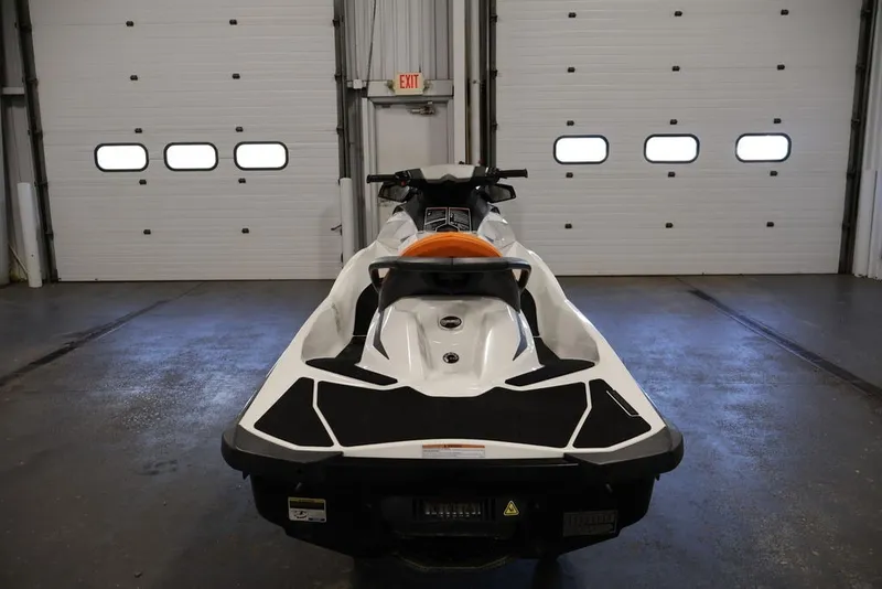 Slide: The Image of 2014 Sea-Doo GTI 130 jet ski in a garage setting. - 2