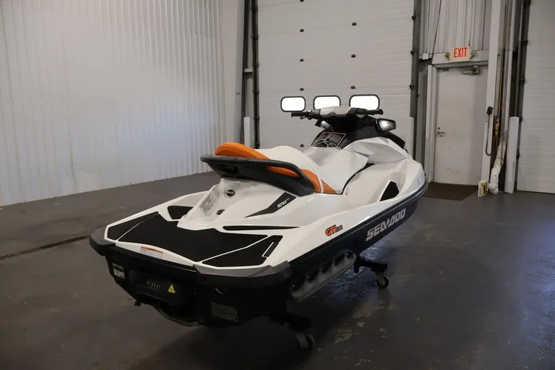 Slide: The Image of 2014 Sea-Doo GTI 130 jet ski in a garage, rear view. - 6