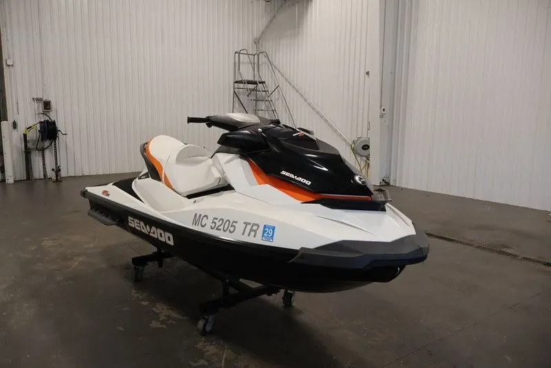Slide: The Image of 2014 Sea-Doo GTI 130 jet ski in a garage setting. - 3