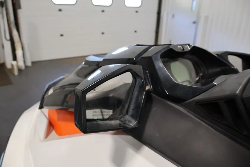 Slide: The Image of 2014 Sea-Doo GTI 130 dashboard and mirrors in a garage setting. - 9