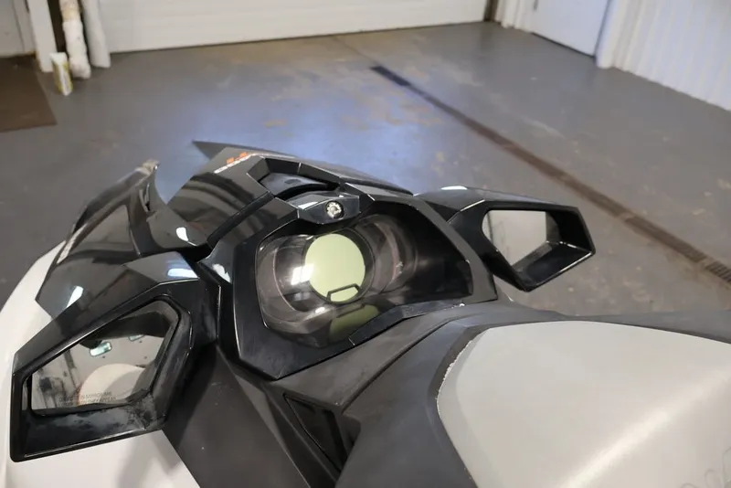 Slide: The Image of 2014 Sea-Doo GTI 130 dashboard and mirrors in a garage setting. - 18