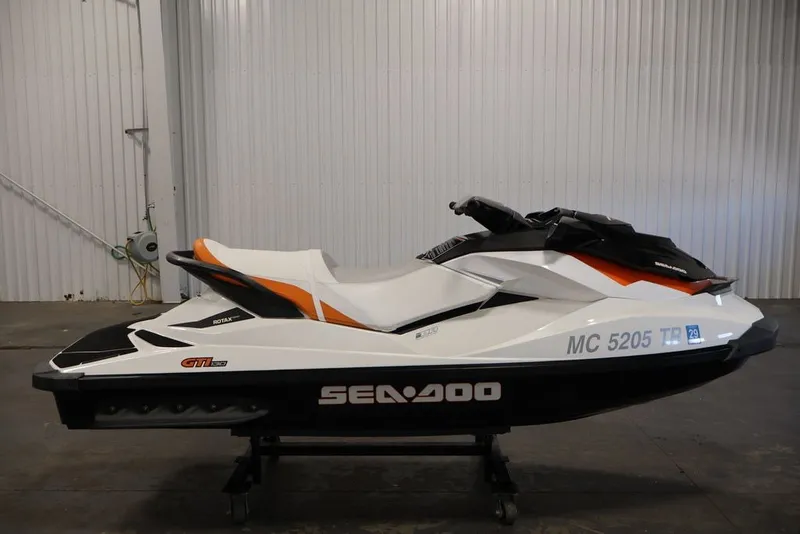 Slide: The Image of 2014 Sea-Doo GTI 130 jet ski in a garage, side view. - 4