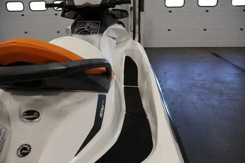 Slide: The Image of 2014 Sea-Doo GTI 130 jet ski with orange seat in a garage setting. - 16