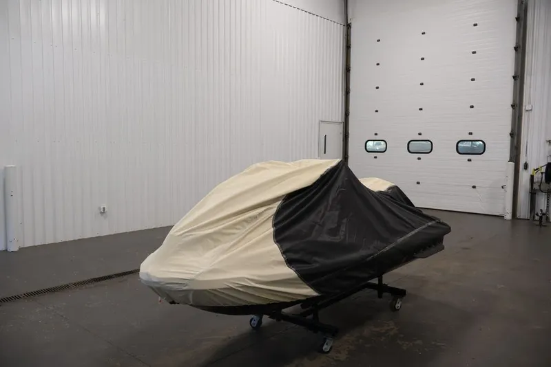 Slide: The Image of 2014 Sea-Doo GTI 130 covered in a garage, ready for storage. - 15