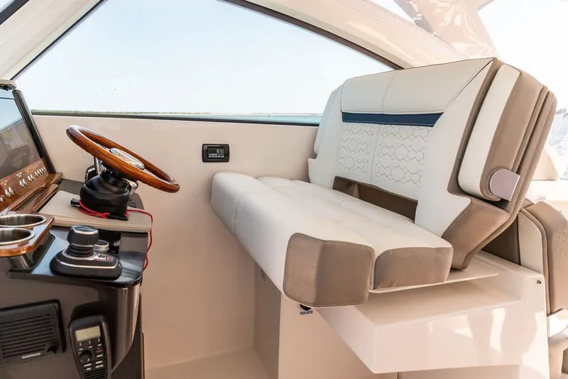 Slide: The Image of 2024 Tiara Yachts 34 LX helm with luxurious seating and modern controls. - 17
