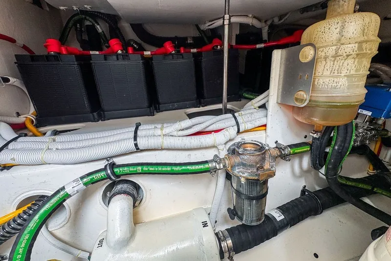 Slide: The Image of Engine compartment of 2024 Tiara Yachts 34 LX, showcasing batteries and wiring. - 46