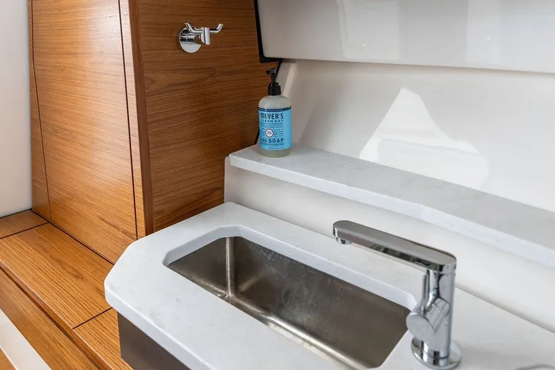 Slide: The Image of 2024 Tiara Yachts 34 LX interior sink with wooden cabinetry and soap dispenser. - 43