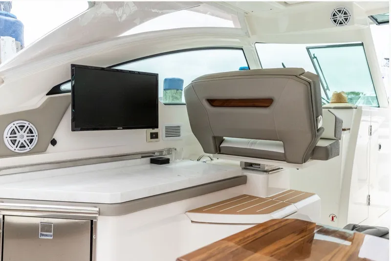 Slide: The Image of 2024 Tiara Yachts 34 LX interior with seating, TV, and modern amenities. - 15