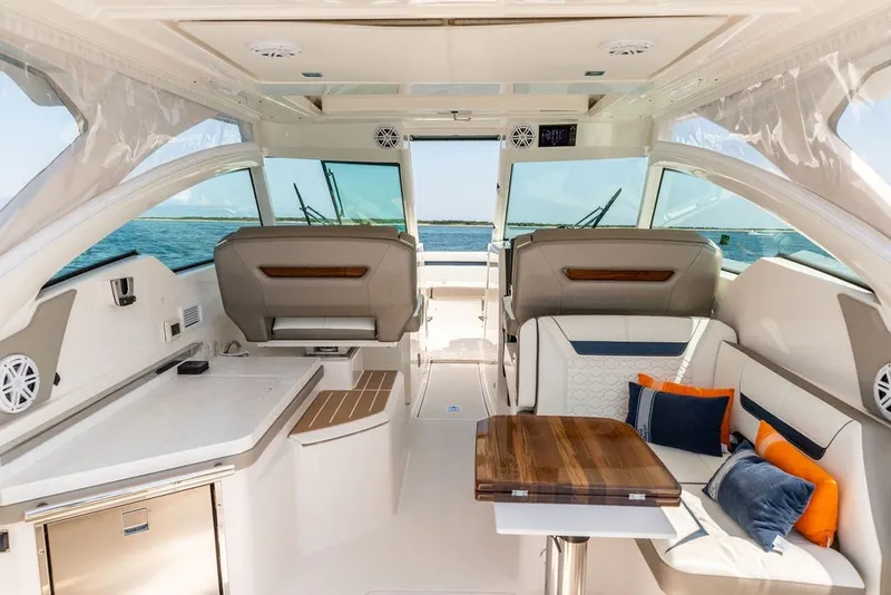 Slide: The Image of 2024 Tiara Yachts 34 LX interior with luxurious seating and ocean view. - 2
