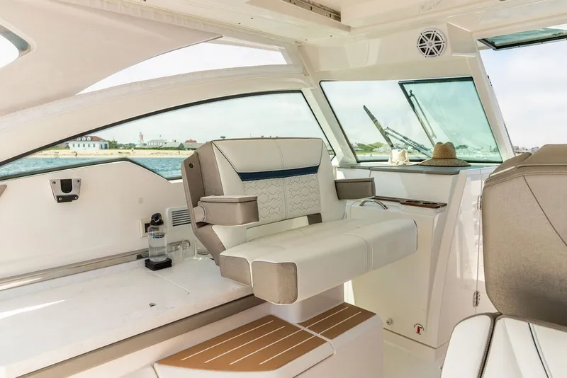 Slide: The Image of Luxurious interior of 2024 Tiara Yachts 34 LX, featuring elegant seating and panoramic windows. - 14
