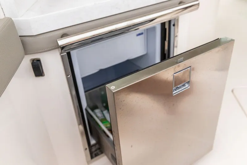 Slide: The Image of Stainless steel refrigerator on 2024 Tiara Yachts 34 LX, open to reveal interior. - 24