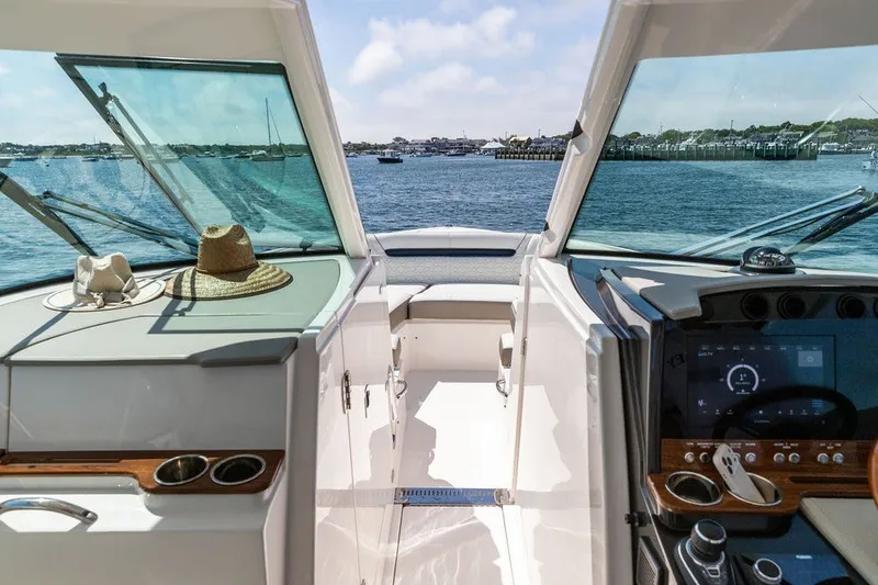 Slide: The Image of 2024 Tiara Yachts 34 LX cockpit view with scenic ocean backdrop. - 27