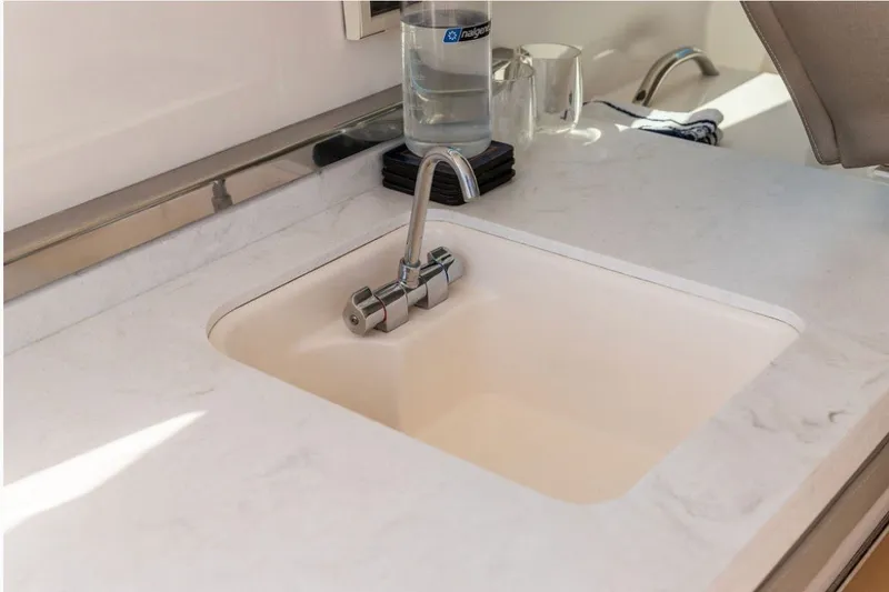 Slide: The Image of Luxury sink area on 2024 Tiara Yachts 34 LX, featuring sleek design and modern fixtures. - 25