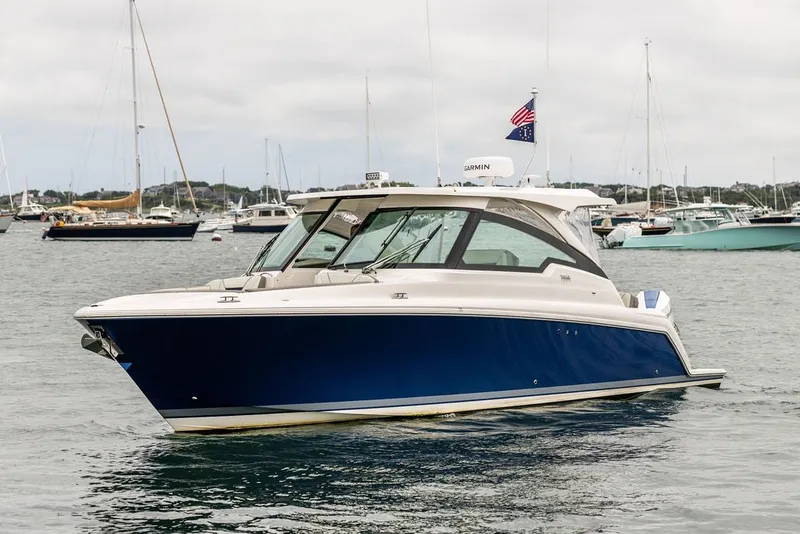 Slide: The Image of 2024 Tiara Yachts 34 LX in a marina, showcasing sleek design and luxury features. - 5