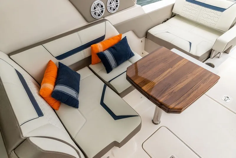 Slide: The Image of Luxurious seating area on 2024 Tiara Yachts 34 LX with cushions and wooden table. - 34