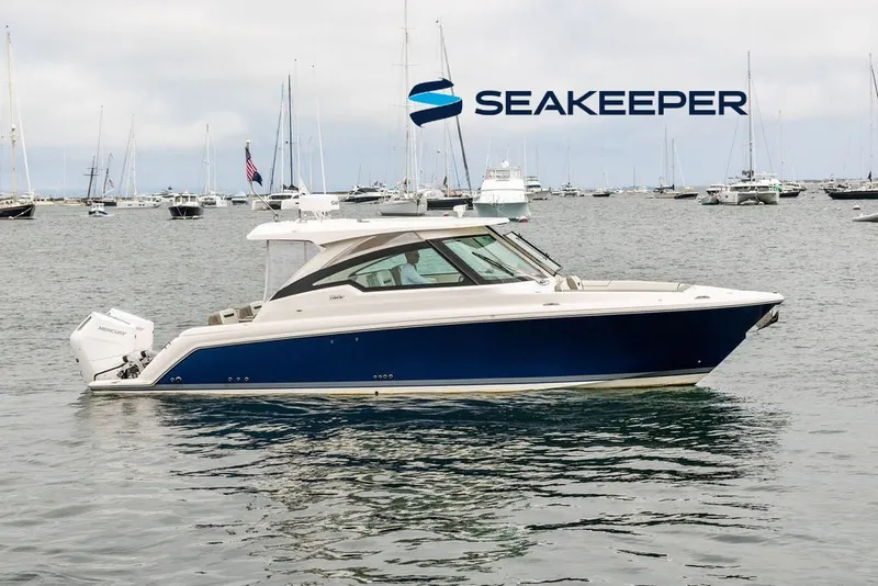 The Image of 2024 Tiara Yachts 34 LX in water, featuring Seakeeper technology, with boats in the background. - 0