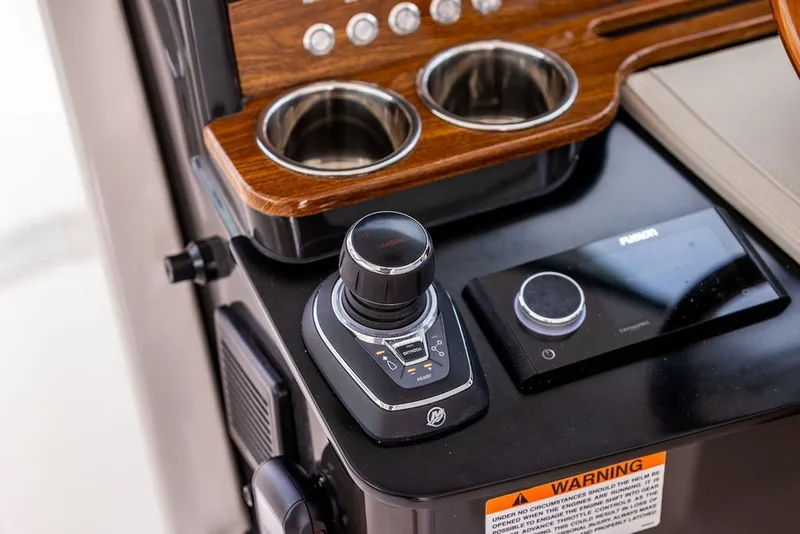 Slide: The Image of 2024 Tiara Yachts 34 LX helm controls with joystick and cup holders. - 21