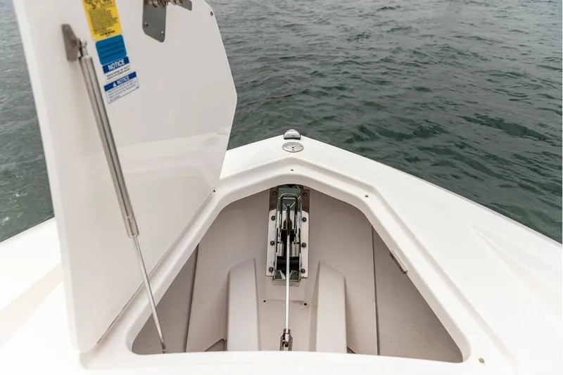 Slide: The Image of Open anchor compartment on 2024 Tiara Yachts 34 LX, showcasing marine hardware. - 28