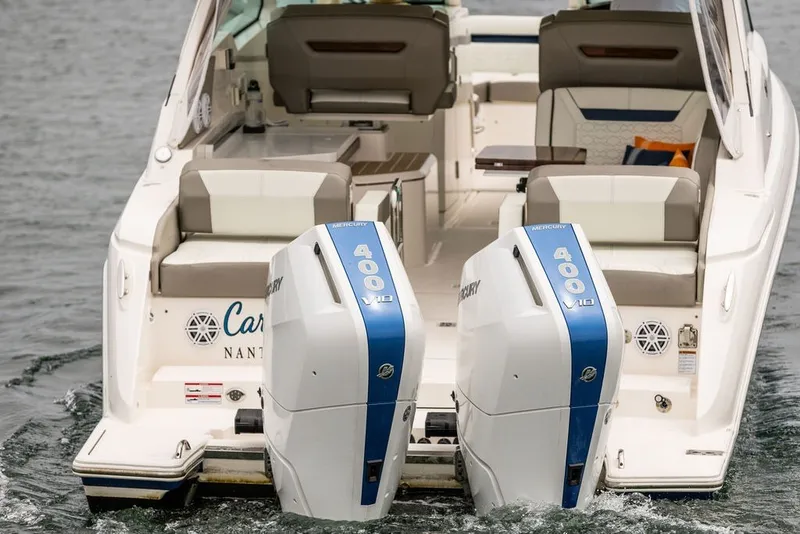 Slide: The Image of 2024 Tiara Yachts 34 LX with dual Mercury 400 V10 engines on water. - 7