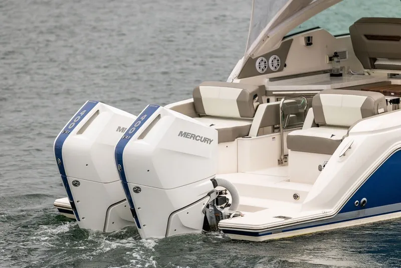 Slide: The Image of 2024 Tiara Yachts 34 LX with dual Mercury outboard engines on water. - 41