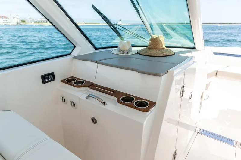 Slide: The Image of 2024 Tiara Yachts 34 LX interior with cup holders and scenic ocean view. - 13