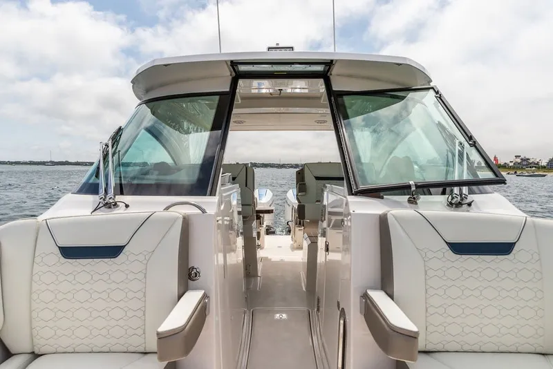 Slide: The Image of 2024 Tiara Yachts 34 LX luxury boat interior with elegant seating and panoramic windows. - 32