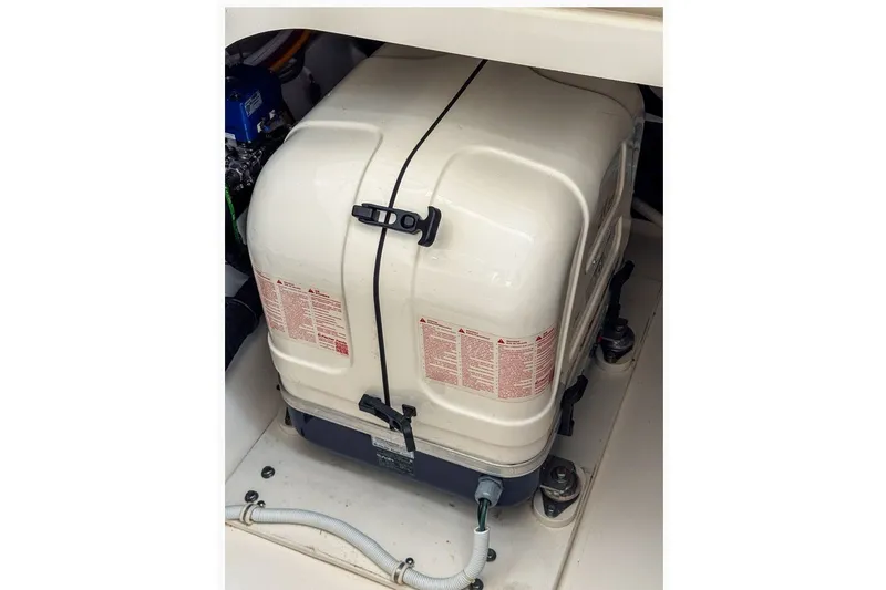 Slide: The Image of Engine compartment of 2024 Tiara Yachts 34 LX, featuring a secured generator. - 48