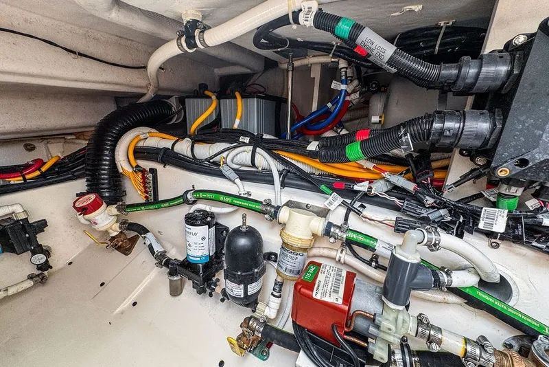 Slide: The Image of Engine compartment of 2024 Tiara Yachts 34 LX, showcasing complex wiring and components. - 45