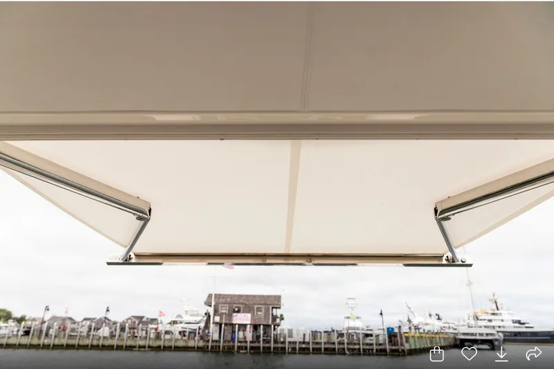 Slide: The Image of 2024 Tiara Yachts 34 LX awning view at marina, showcasing sleek design. - 11