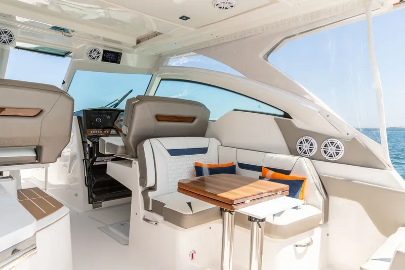 Slide: The Image of 2024 Tiara Yachts 34 LX interior with seating, table, and helm station. - 22