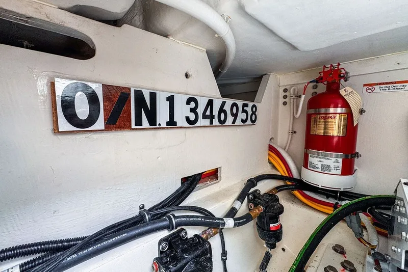 Slide: The Image of Engine compartment of 2024 Tiara Yachts 34 LX with fire extinguisher and registration number. - 44