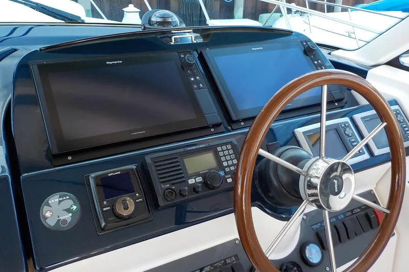 Slide: The Image of 2009 Tiara Yachts 3900 Open helm with dual Raymarine displays and wooden steering wheel. - 8