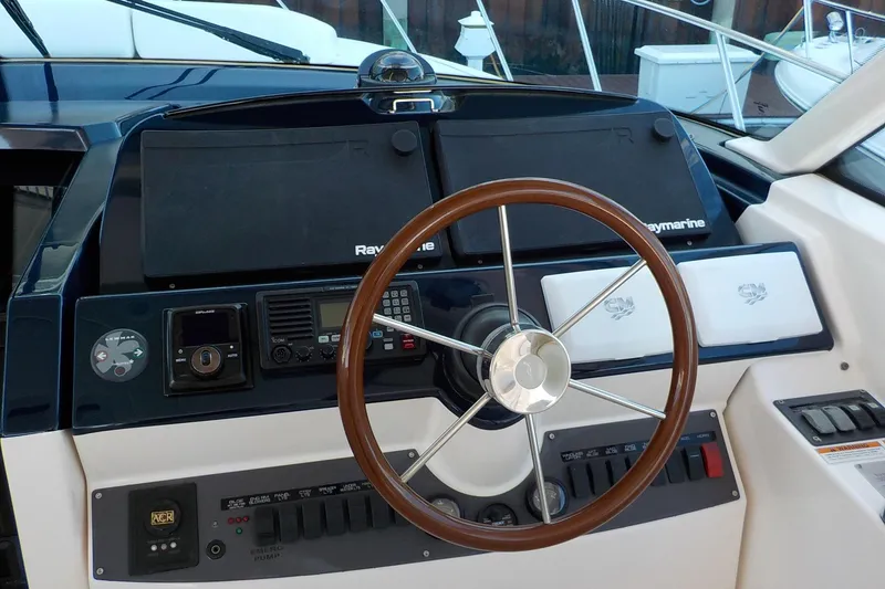 Slide: The Image of 2009 Tiara Yachts 3900 Open helm with Raymarine electronics and wooden steering wheel. - 7