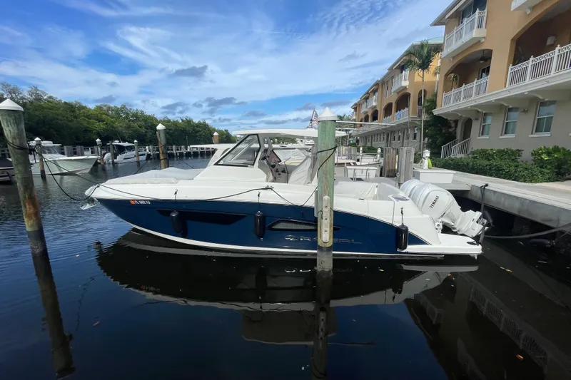 The Image of 2022 Regal 33 SAV boat docked at marina, featuring sleek design and Yamaha engines. - 0