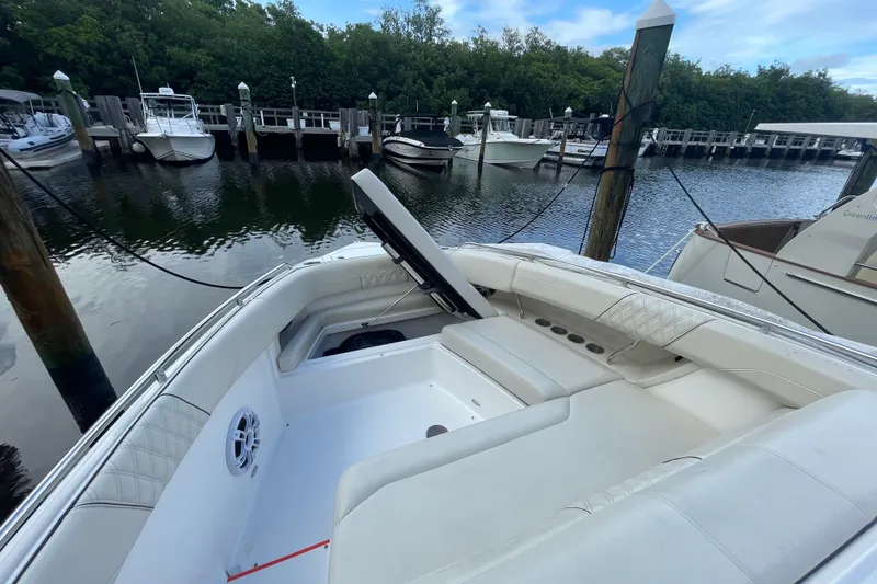 Slide: The Image of 2022 Regal 33 SAV boat with luxurious seating at a marina dock. - 18