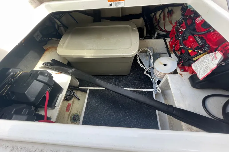 Slide: The Image of 2022 Regal 33 SAV boat storage compartment with equipment and battery setup. - 27