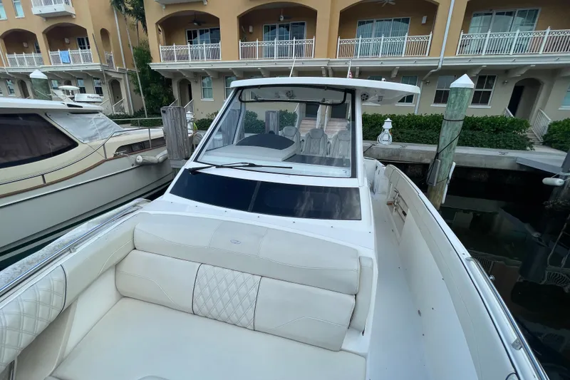 Slide: The Image of 2022 Regal 33 SAV boat docked, featuring luxurious white seating and sleek design. - 20