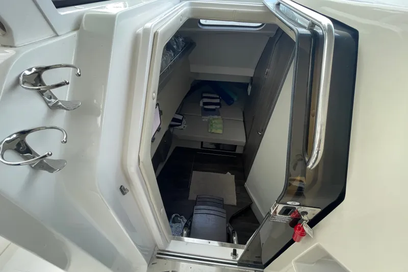 Slide: The Image of Interior cabin view of a 2022 Regal 33 SAV boat, featuring seating and storage. - 21