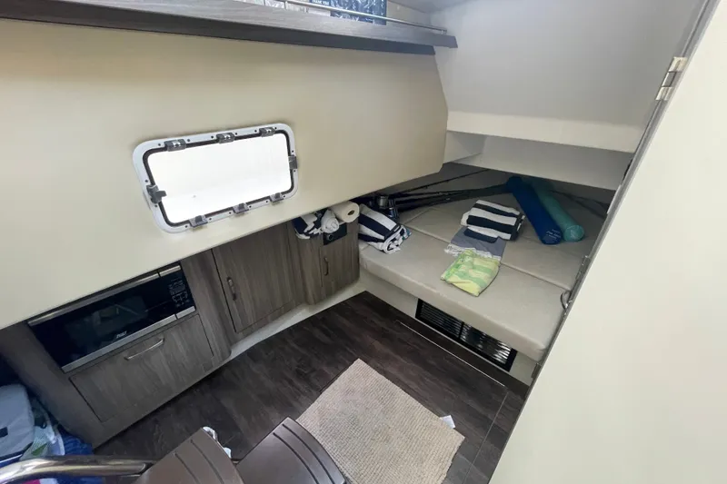 Slide: The Image of Interior cabin of 2022 Regal 33 SAV boat with cozy seating and storage. - 22