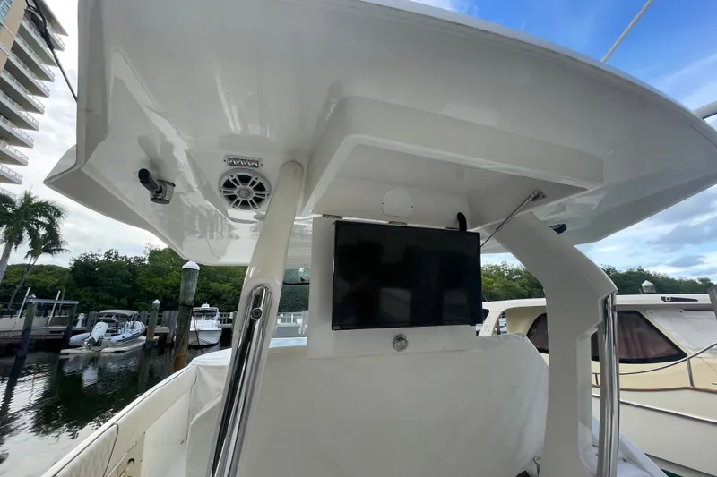 Slide: The Image of 2022 Regal 33 SAV boat interior with TV and speaker, docked at marina. - 13