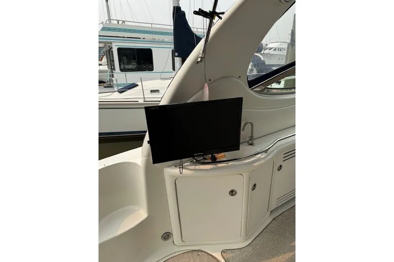 Slide: The Image of Interior of a 2002 Sea Ray 360 Sundancer with mounted TV and cabinetry. - 9