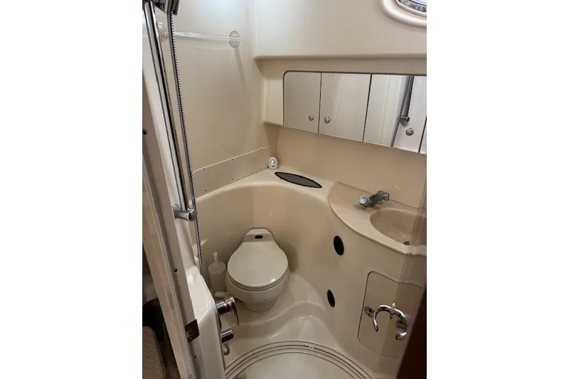 Slide: The Image of Compact bathroom in a 2002 Sea Ray 360 Sundancer yacht, featuring a toilet and sink. - 12