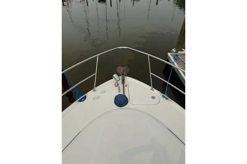 Slide: The Image of Bow view of 2002 Sea Ray 360 Sundancer yacht docked at marina. - 2