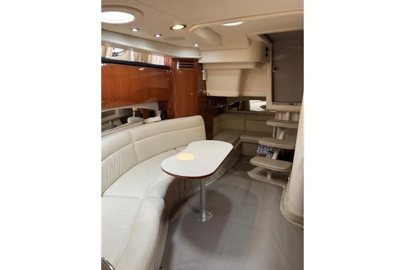 Slide: The Image of Interior of 2002 Sea Ray 360 Sundancer yacht with elegant seating and table. - 11
